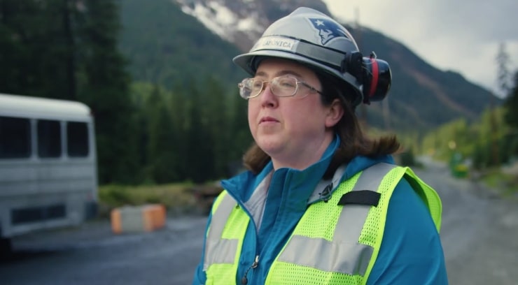 An image of a woman with a patriots hard hat on.